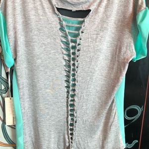 COVER STITCHED BLOUSE WITH BRAIDED T-SHIRT BACK.